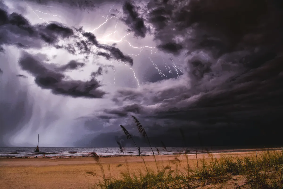 Dramatic storm clouds and lightning over the beach